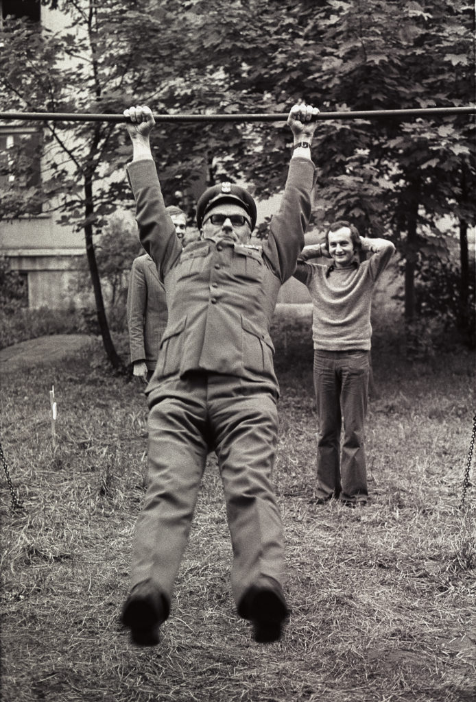 Sciezka zdrowia 1975 otwarcie 1 Żołnierz w mundurze i ciemnych okularach podwiesza się na sprzęcie do ćwiczeń